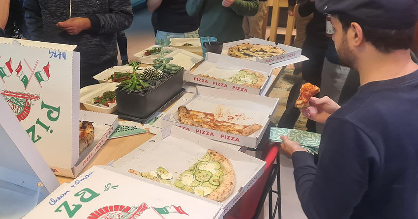 Boxes of pizza being eaten by conference attendees